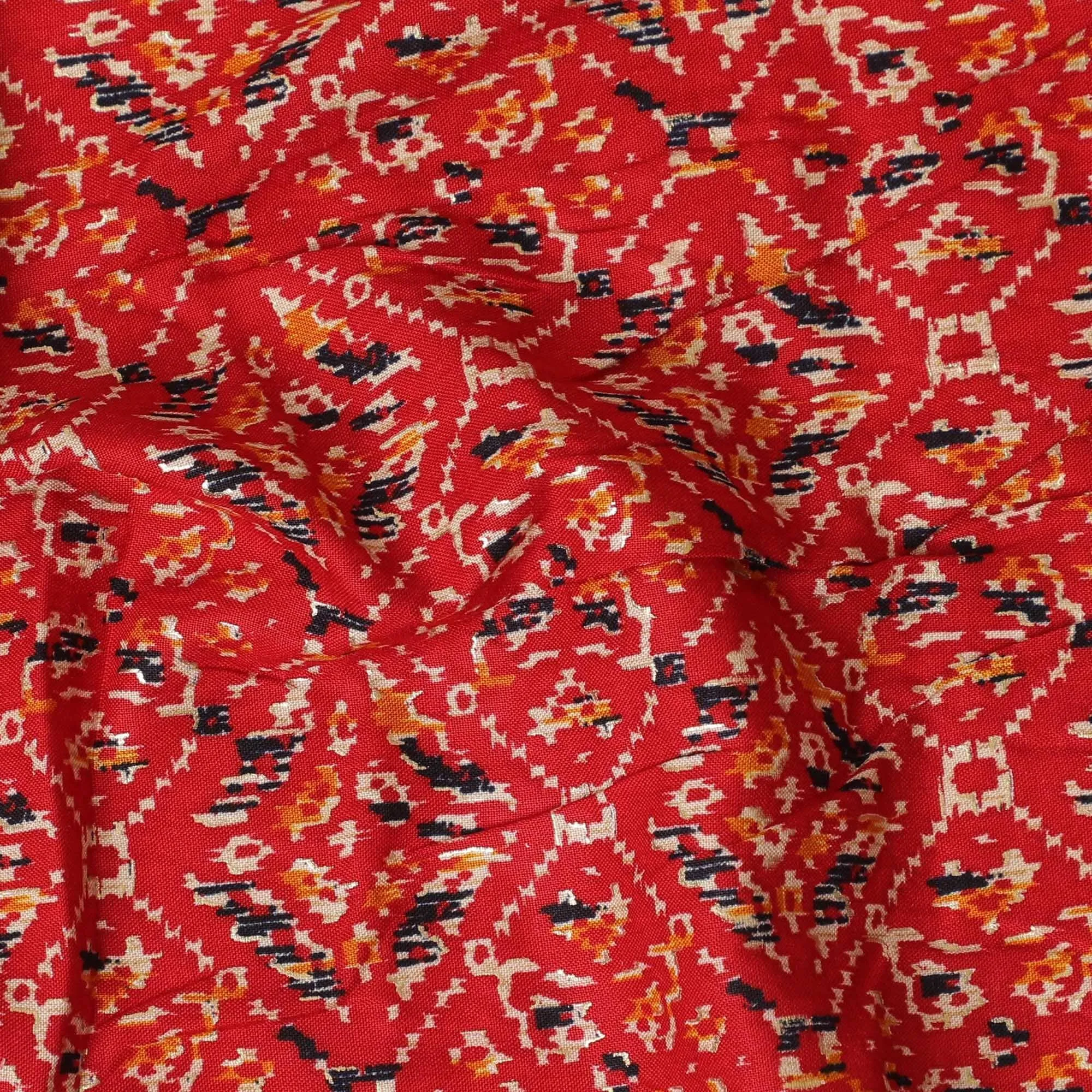 Crimson red cotton viscose fabric with black, orange and gold print in batik design-D14192